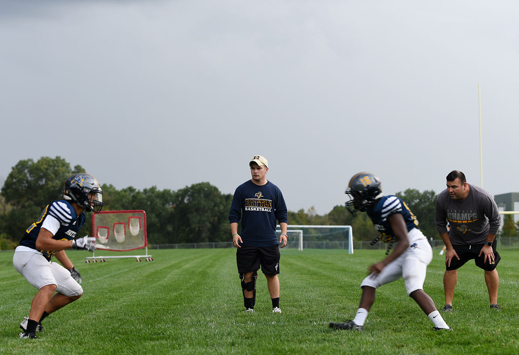 Cody Rachatellelle and coach Miguel Paredes watch players perform a drill